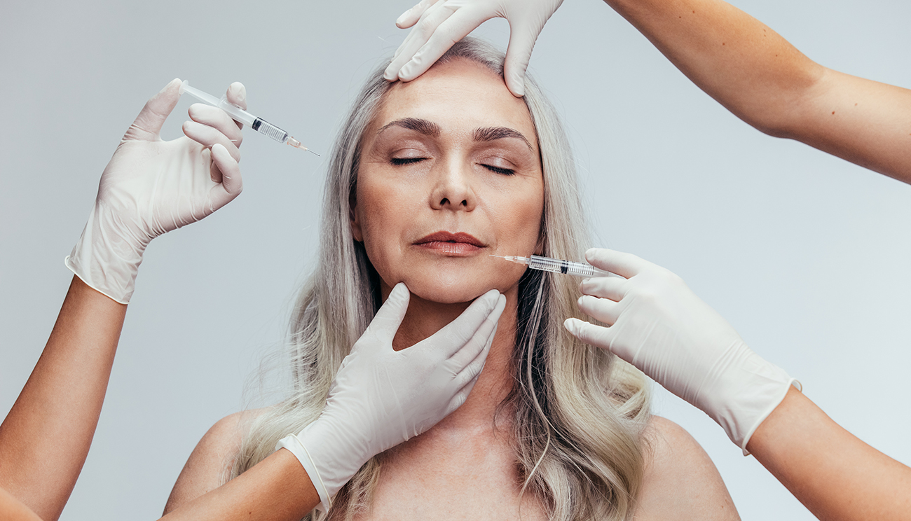 Mature woman receiving anti-aging facial injections